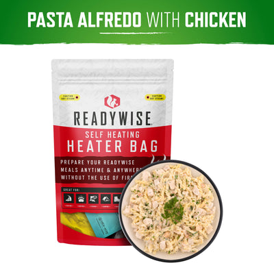 Readywise Pasta Alfredo with Chicken self-heating meal next to a bowl of creamy pasta.